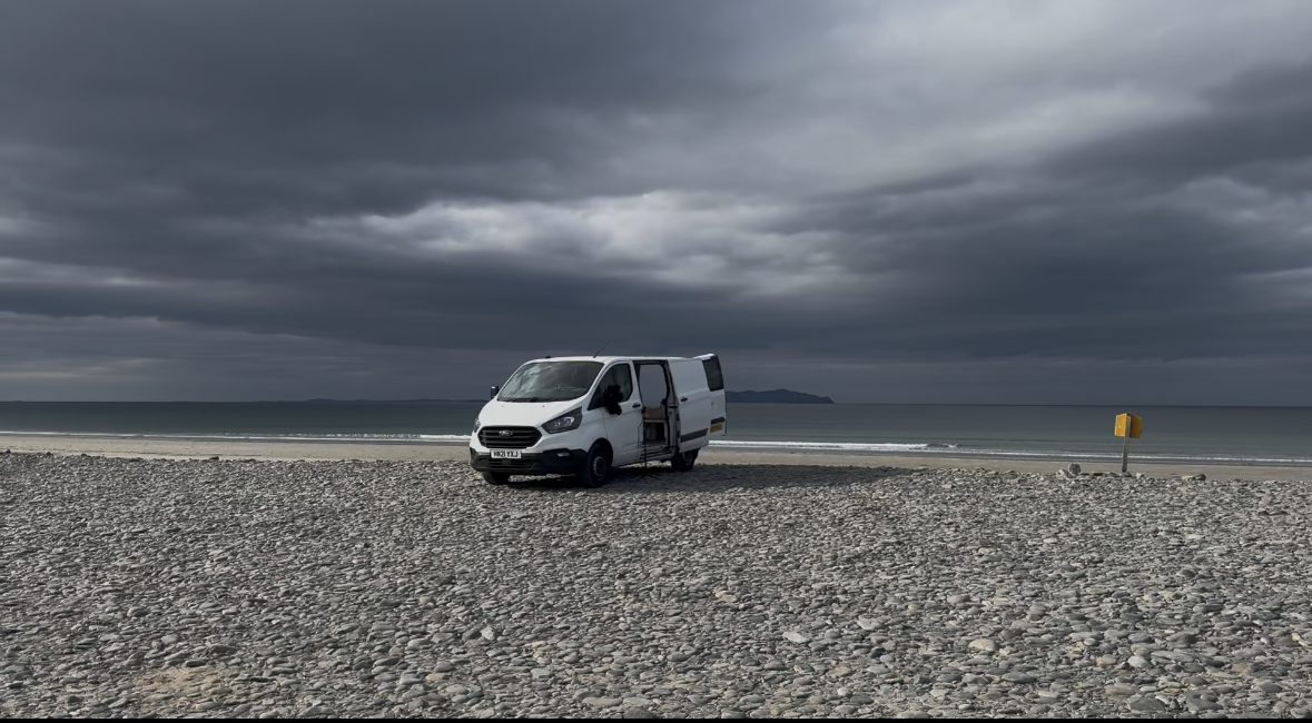 Dom Wright's modified Transit home on a beach.