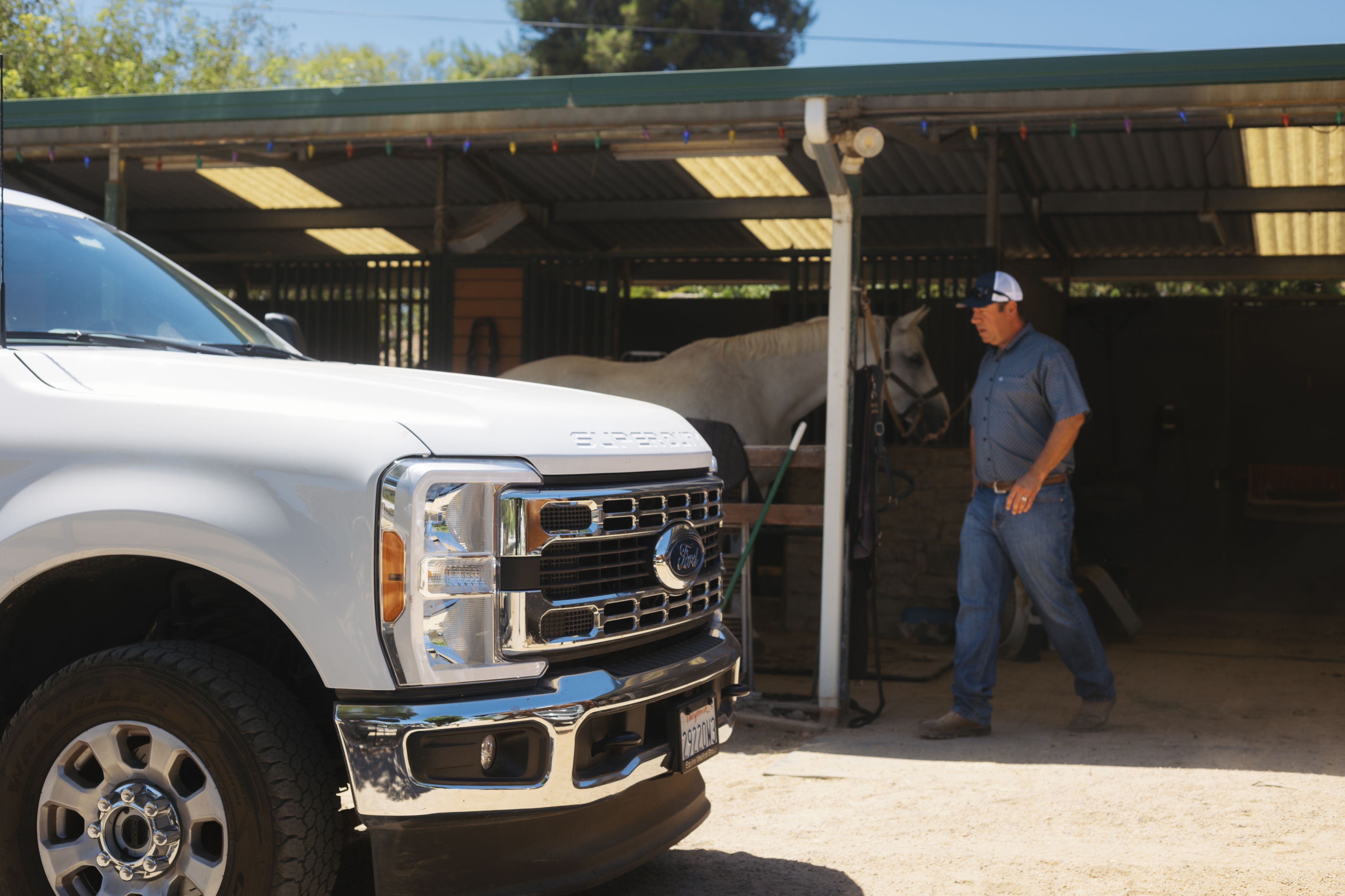 Dr. Bender walks by a horse with his Ford Super Duty® truck in the foreground