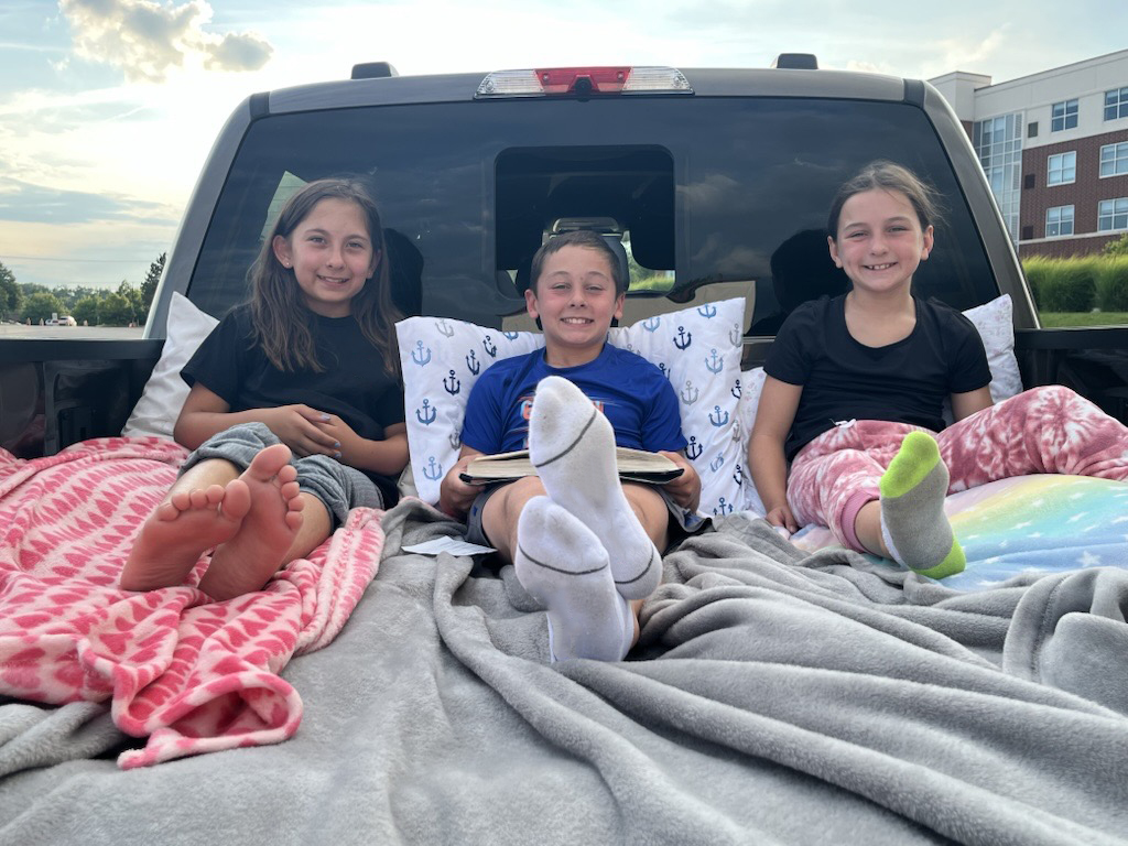 Vince Mahe, chief engineer for the F-150 Lightning, uses Pro Power Onboard in the Mega Power Frunk to inflate a mattress for drive-in movie nights.