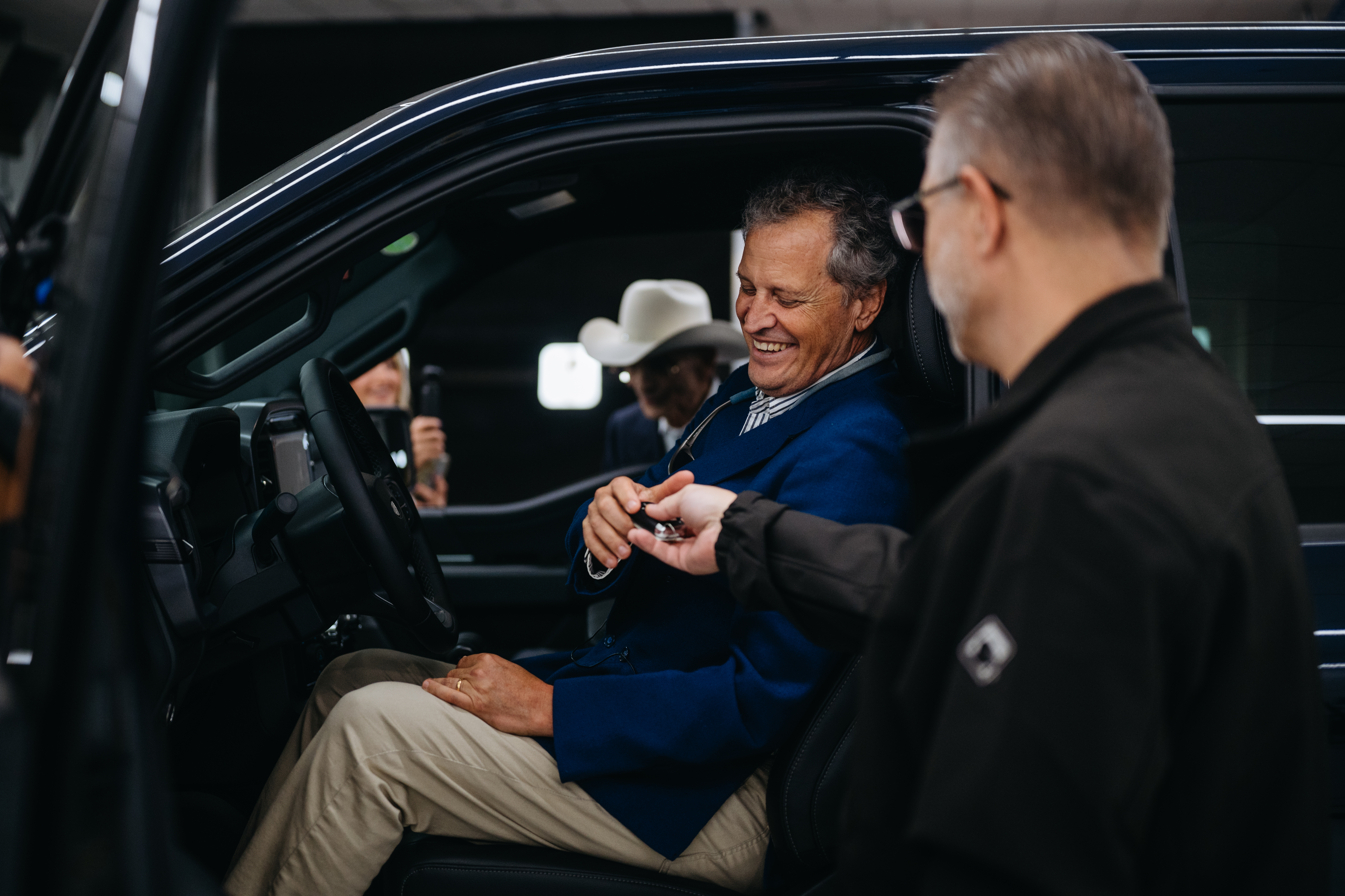 F-150 Chief Engineer John Lo Porto hands Marc Fogel the keys to his new Ford F-150 truck.