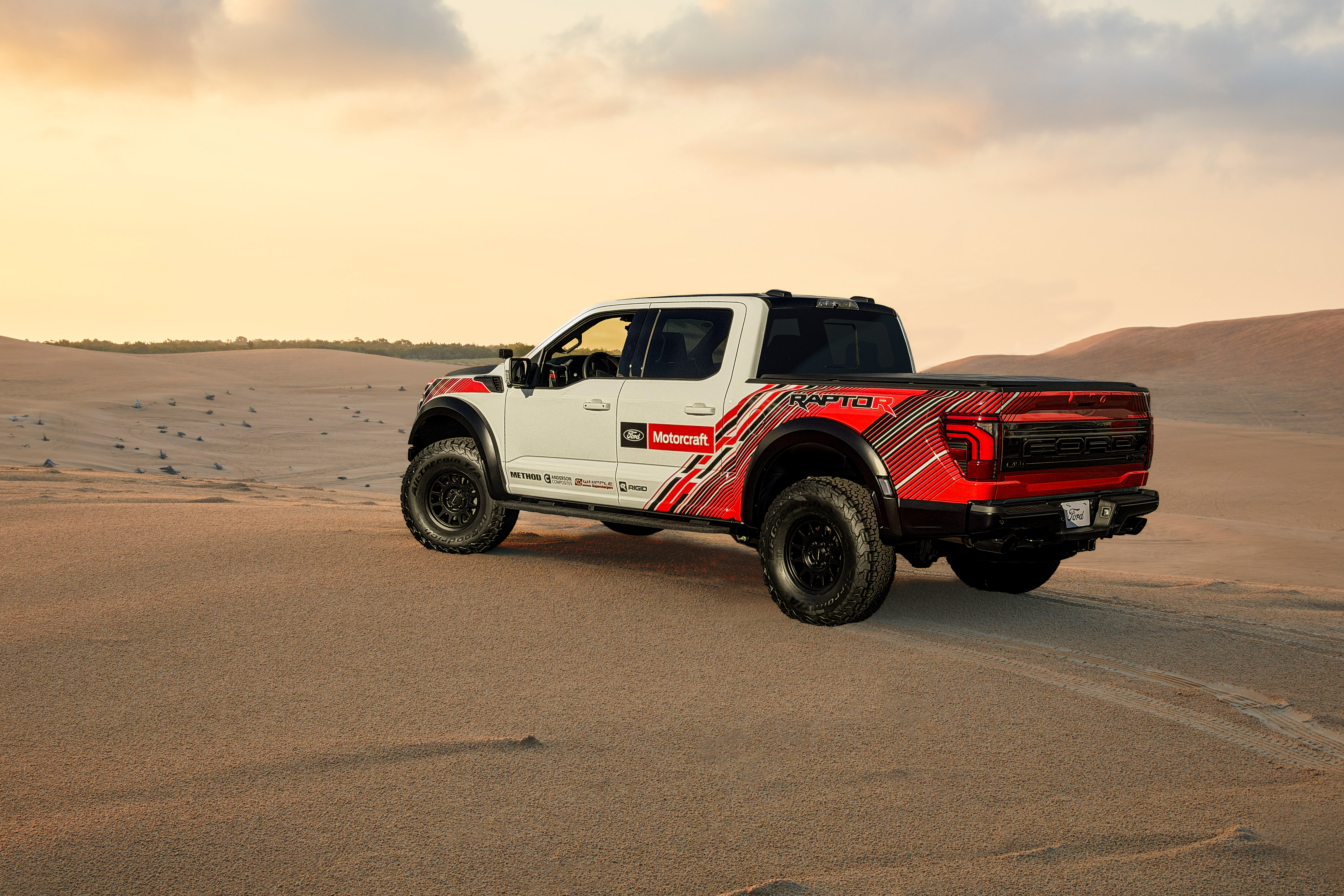 White and red F-150 Raptor R on the sand