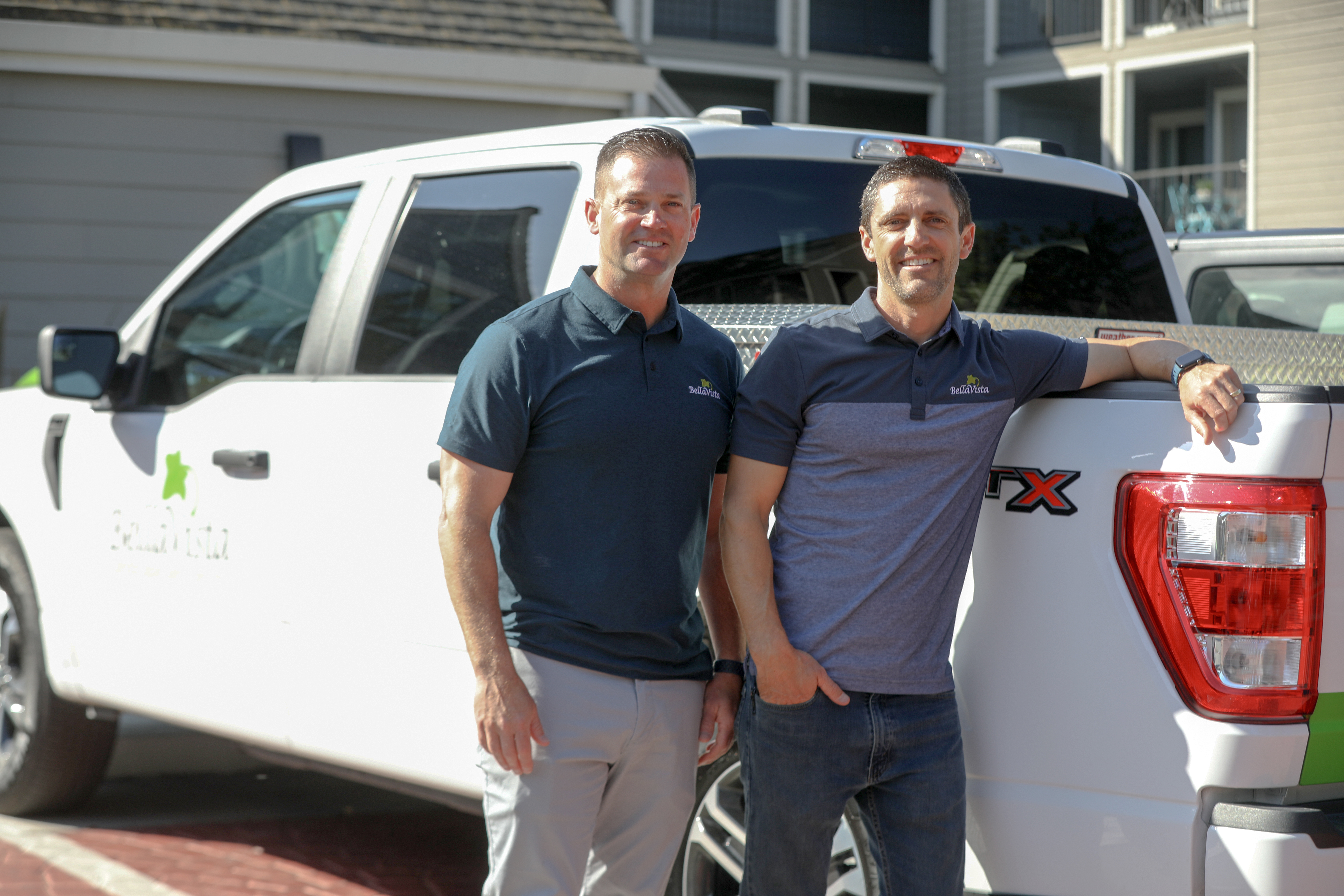 Matt (left) and Brian (right) pose next to a Ford truck. 