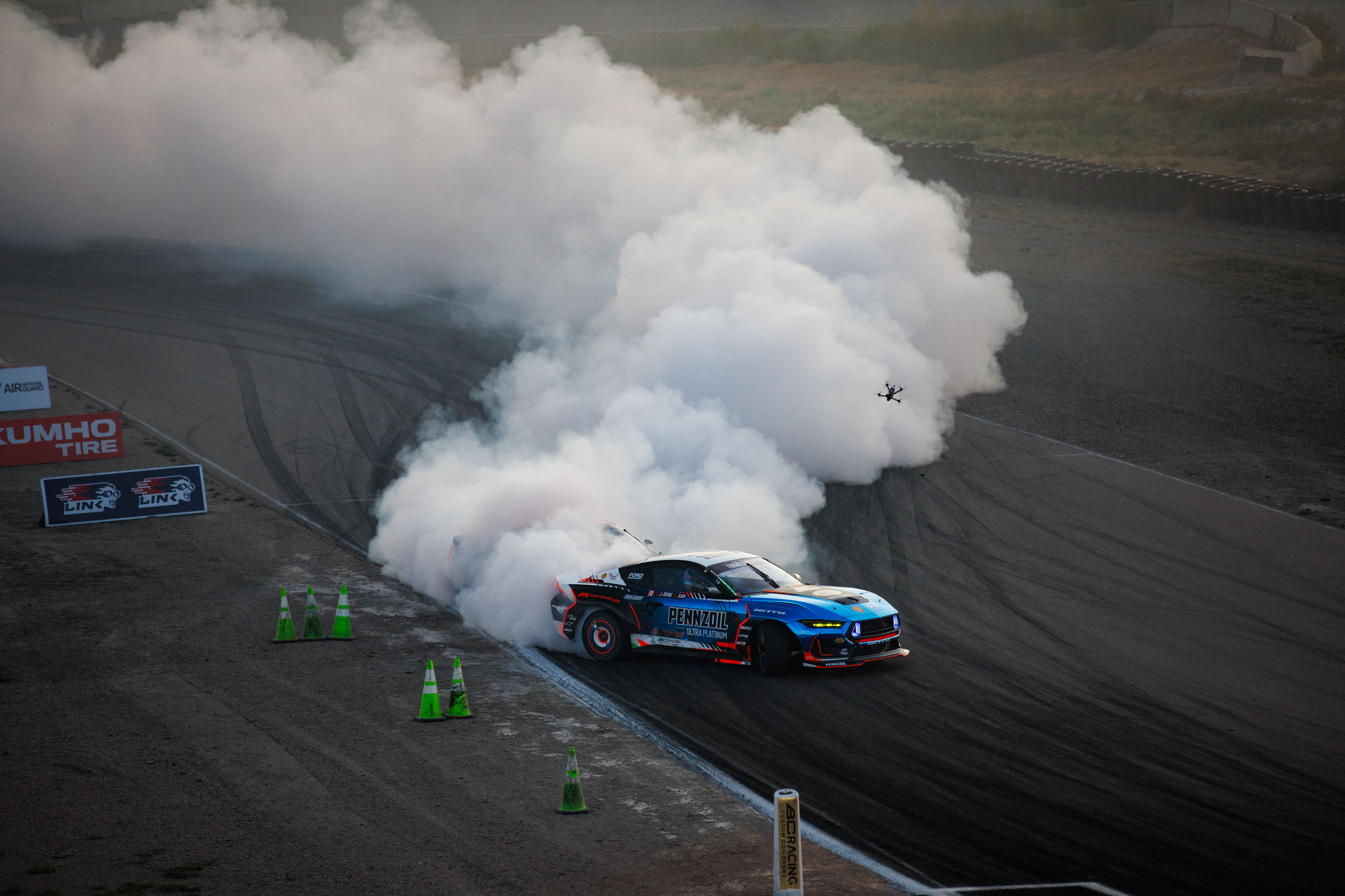 A Mustang drifts on a racetrack