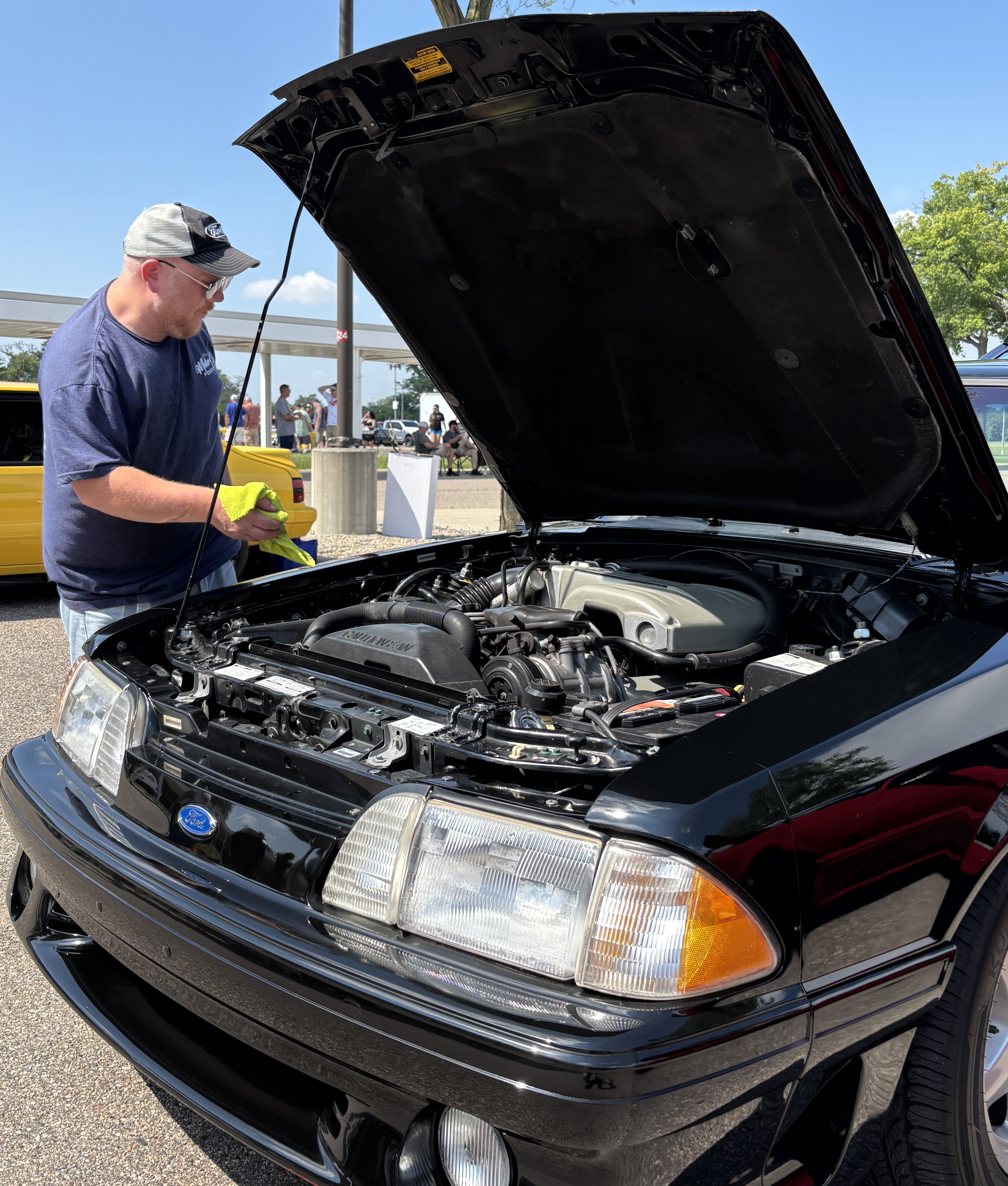 Dave Tressler of New Kensington, Pennsylvania, prepares his 1993 Ford Mustang GT for show at the 3rd annual Motor City Foxfest in Dearborn, Michigan, on Saturday, July 12, 2025.