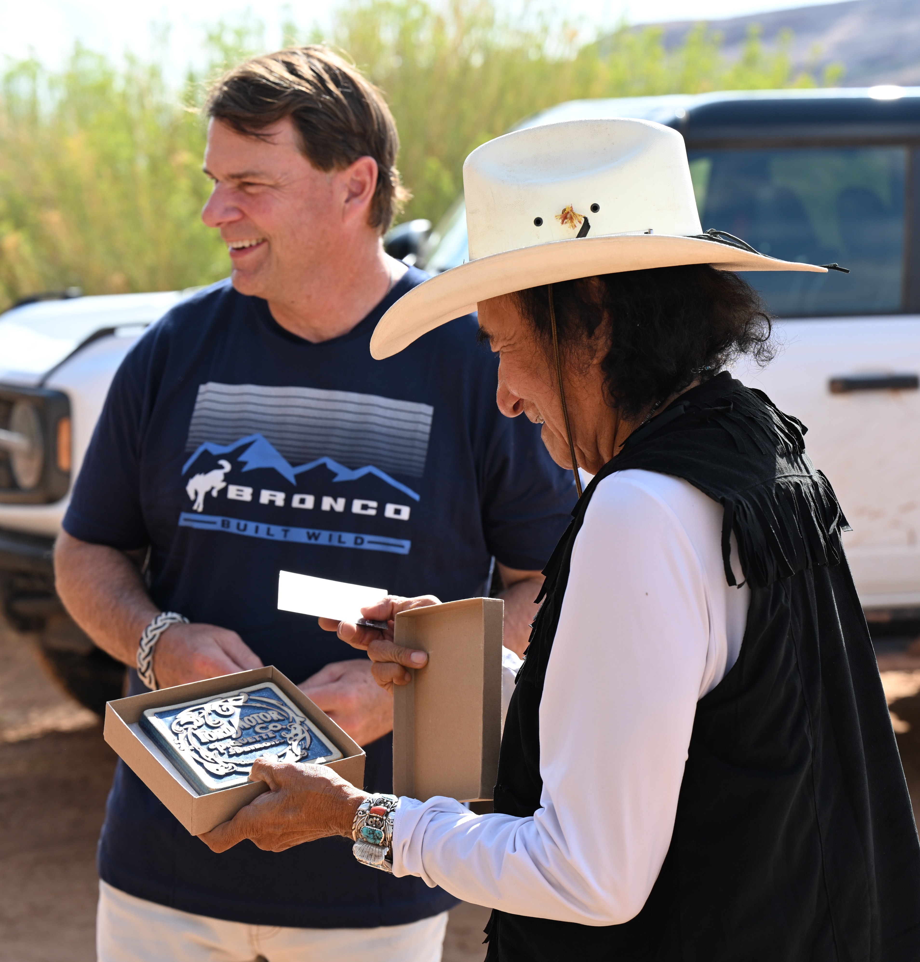 Jim Farley gifts Don Mose a Ford Motor Co. Pewabic tile. 