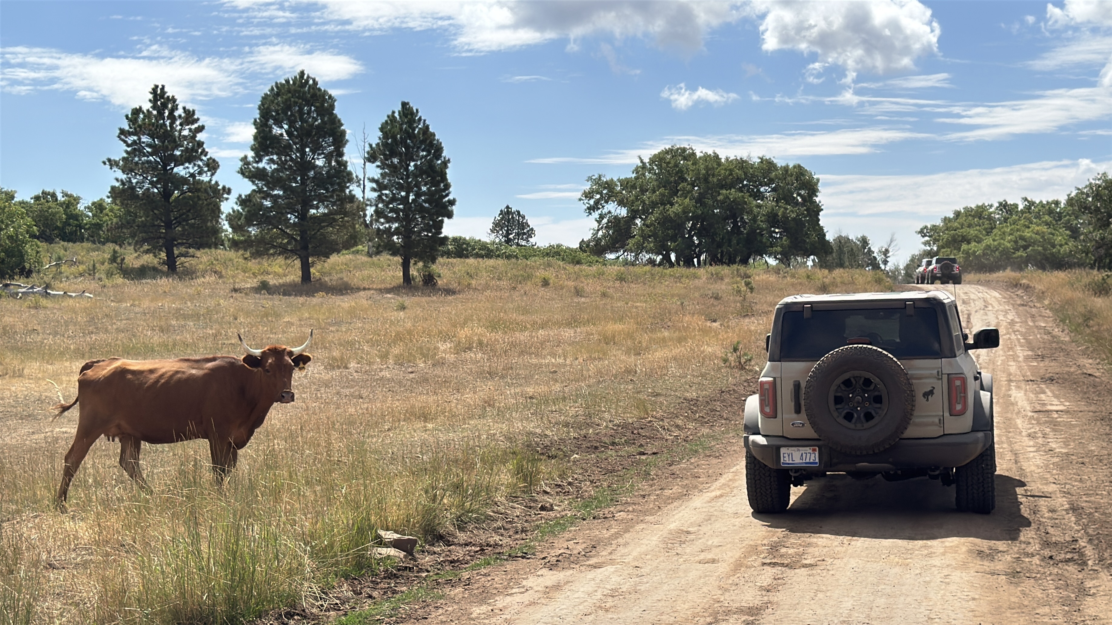 Jim Farley and his daughter Lilly pass a friend along their drive out of Moab.