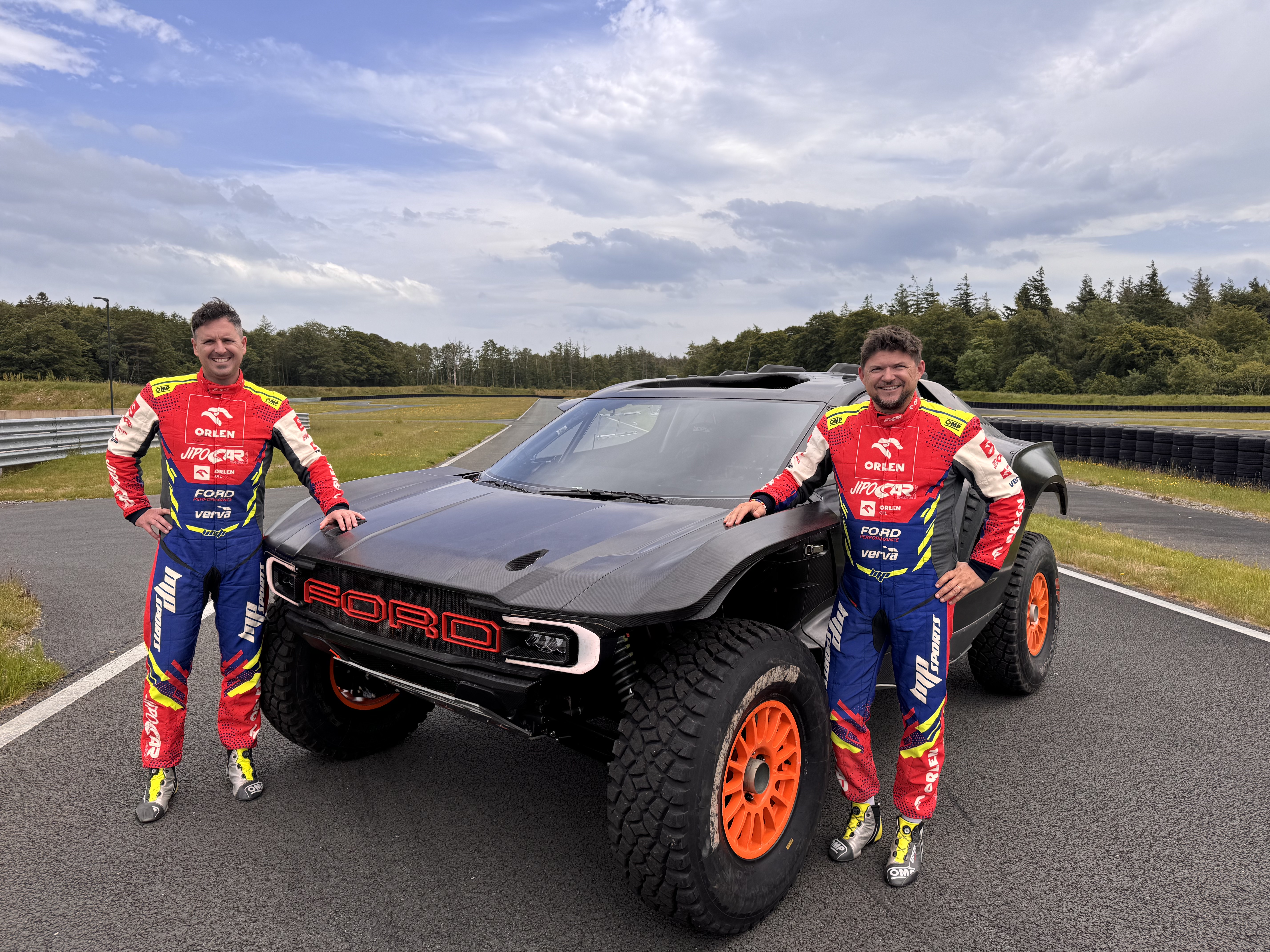 Navigator/co-driver Viktor Chytka (left) and driver Martin Prokop (right) on the grounds of M-Sport with their Ford Raptor T1+.