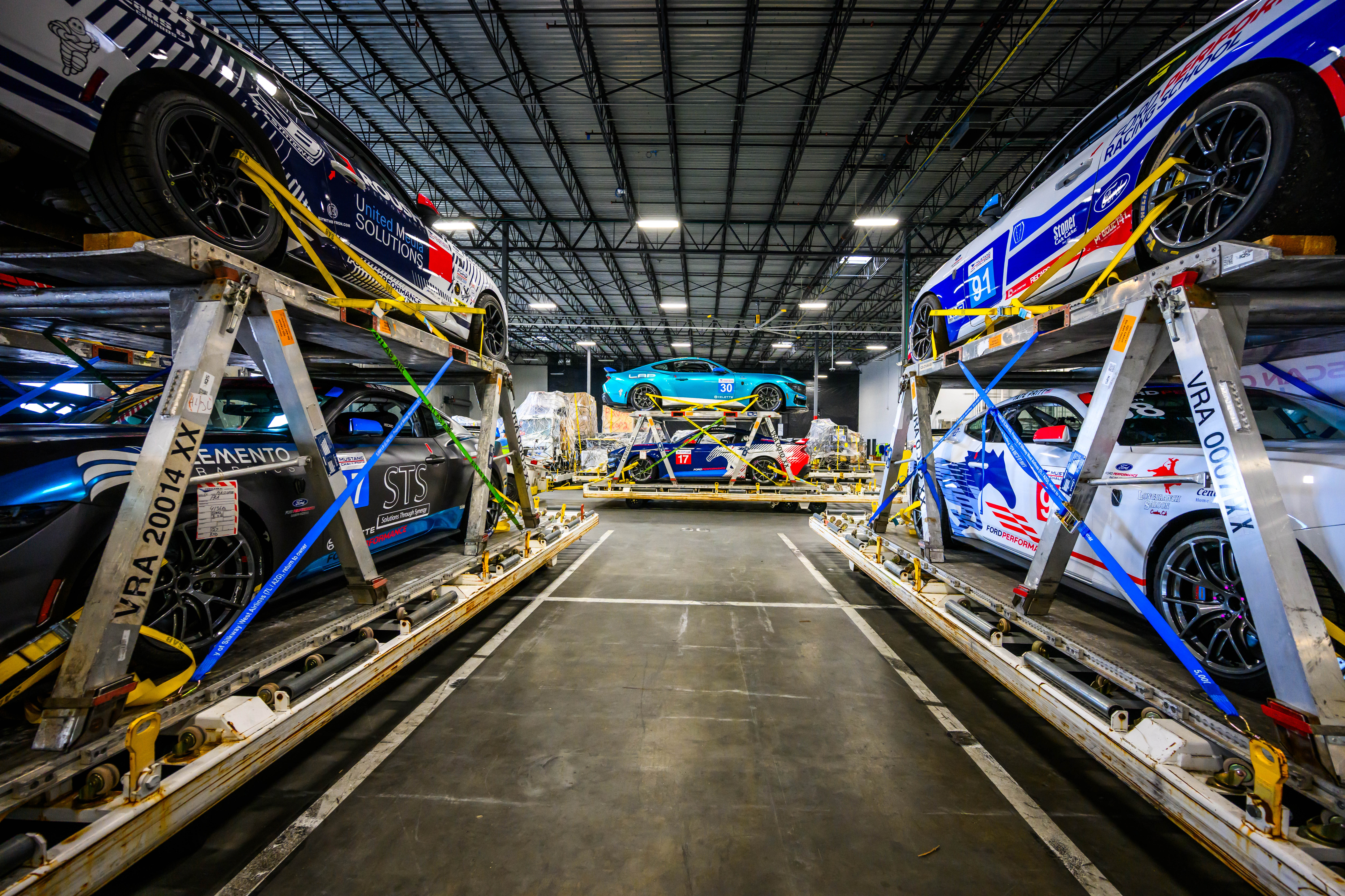 Mustang Dark Horse R race cars stored in a warehouse in preparation for Le Mans.