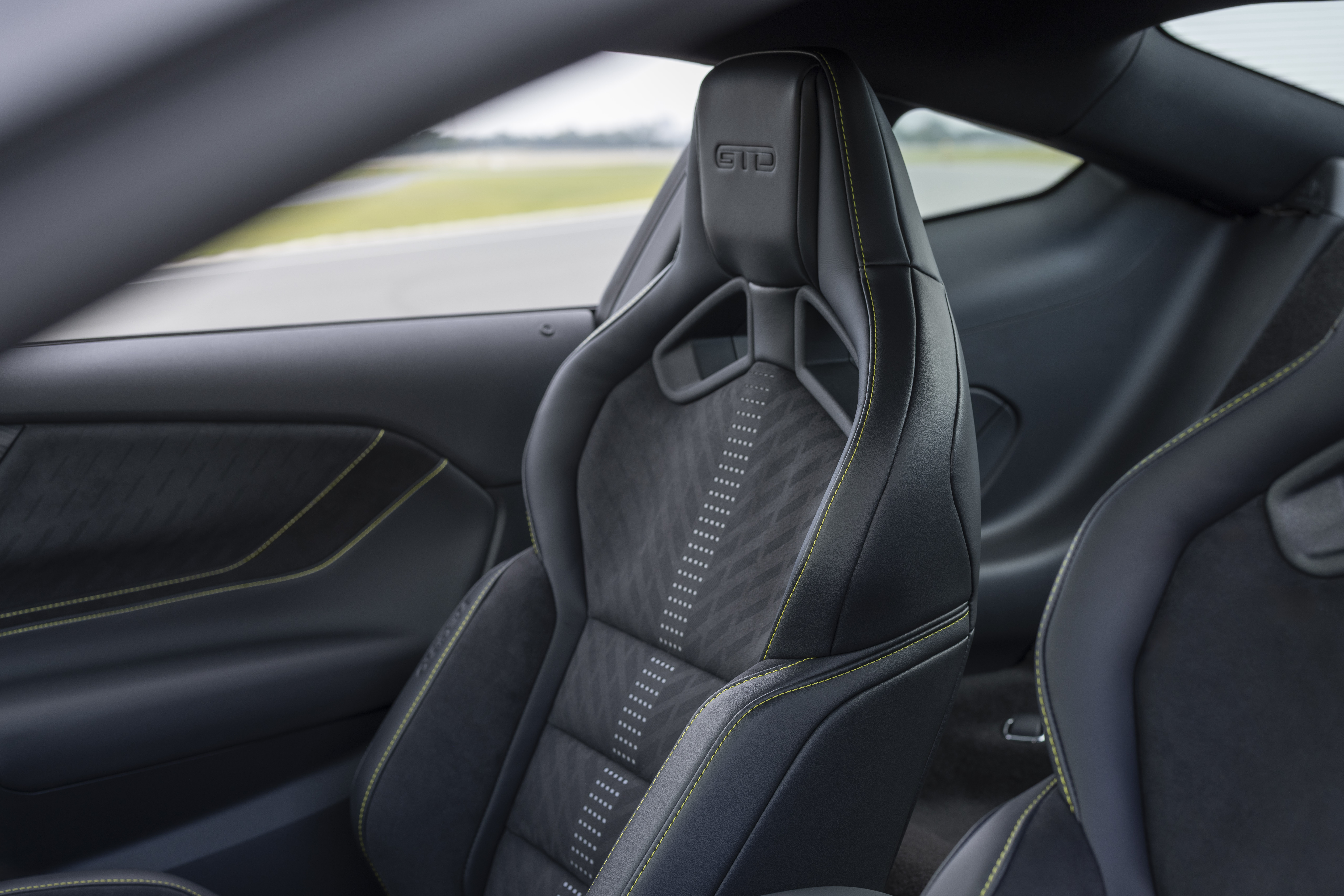 New Mustang Liquid Carbon interior shows lime green stitching on black and grey interior fabric.