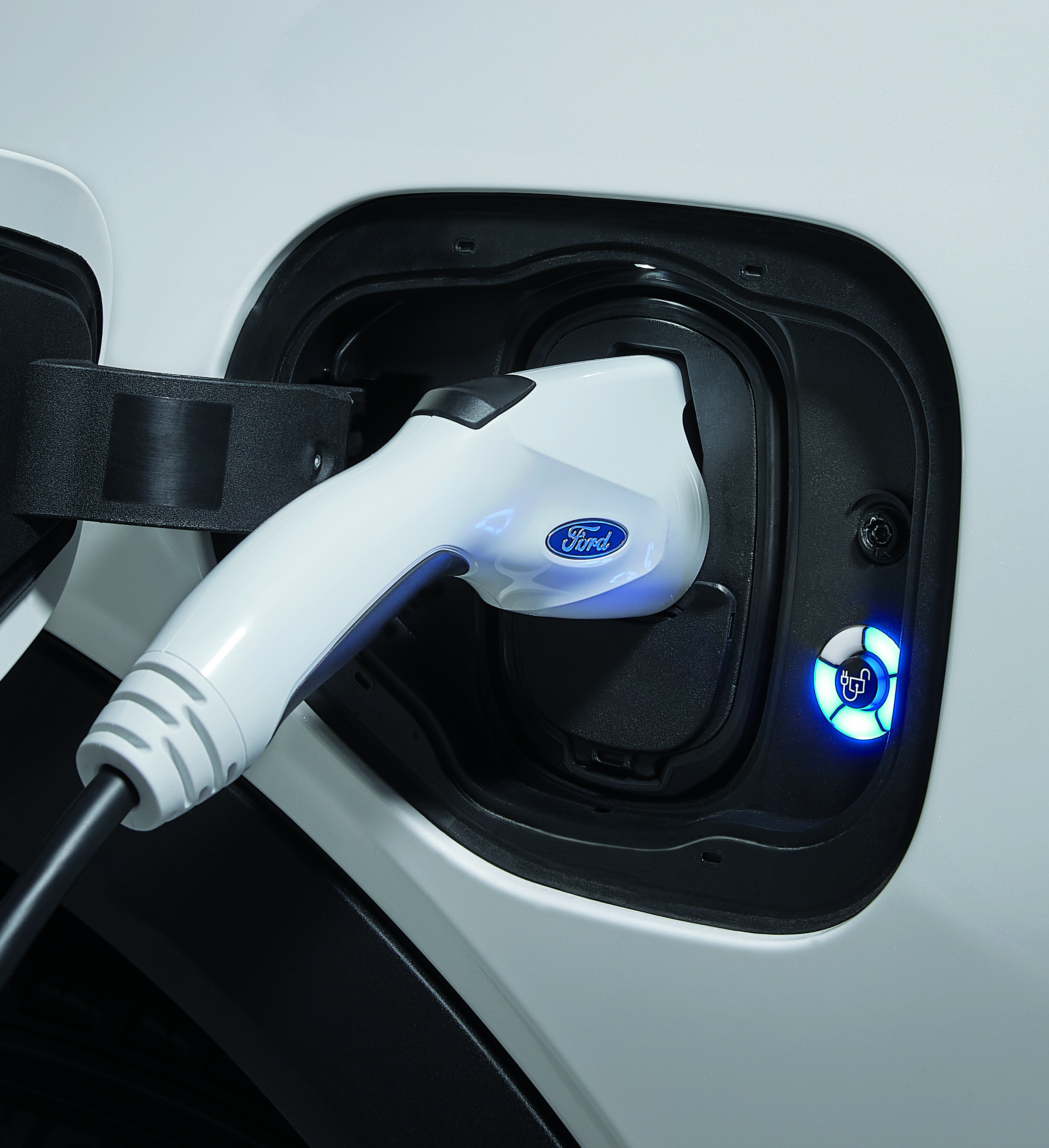 A Ford Pro electric vehicle charger plugged into a vehicle