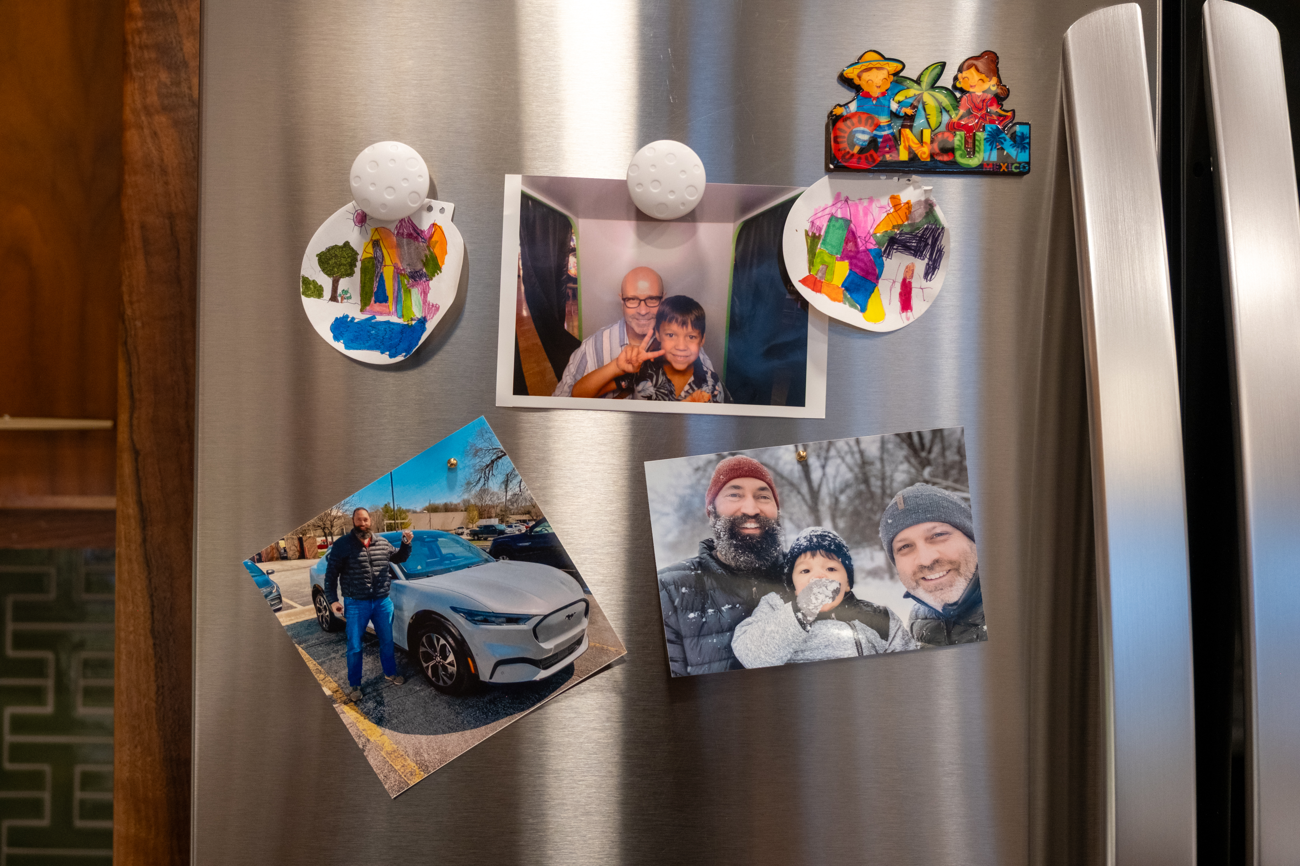 A close-up of photos on Todd's refrigerator.