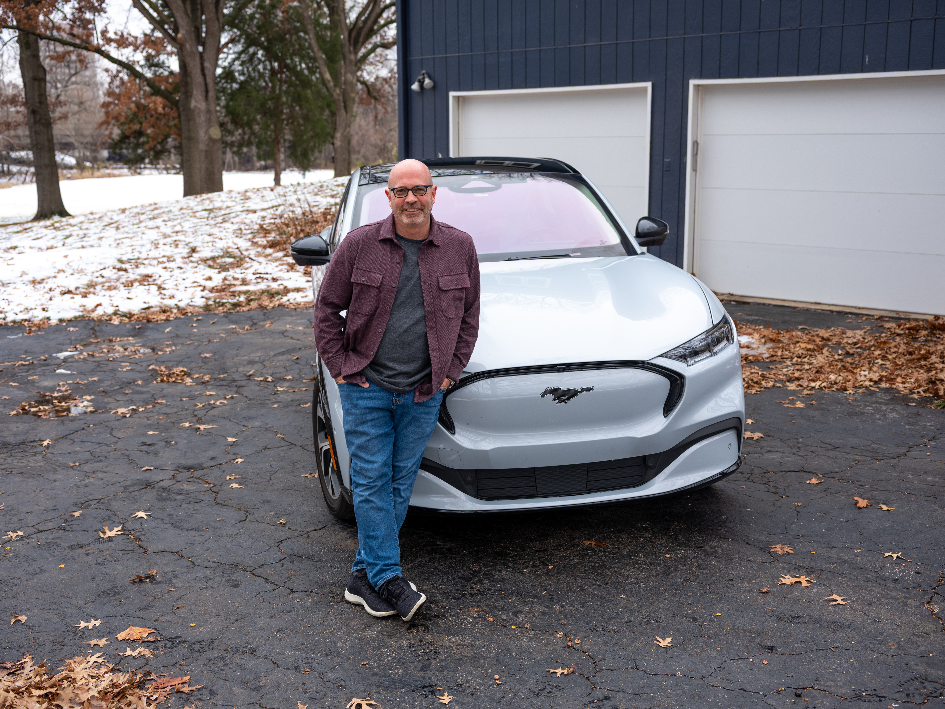 Todd posing with the Mustang Mach-E.