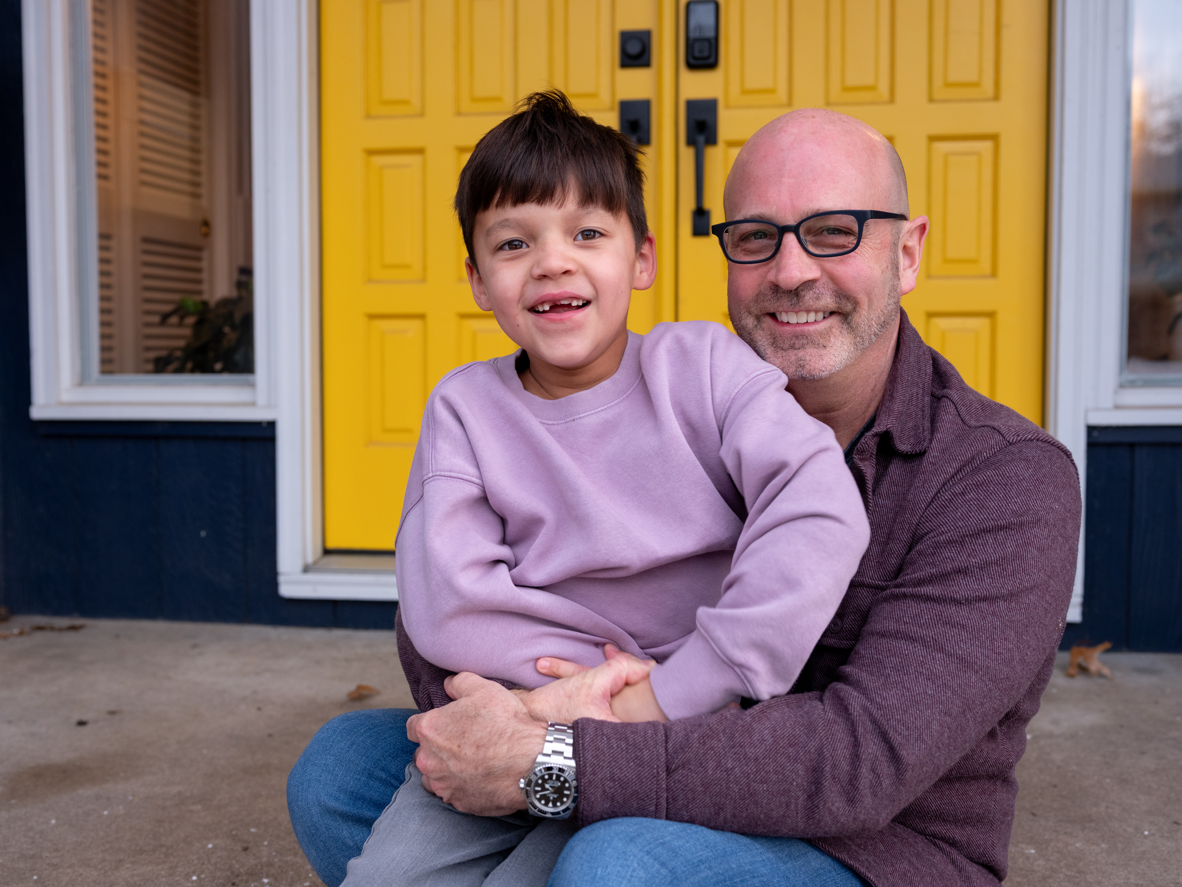 Todd and Oliver in front of their front door.