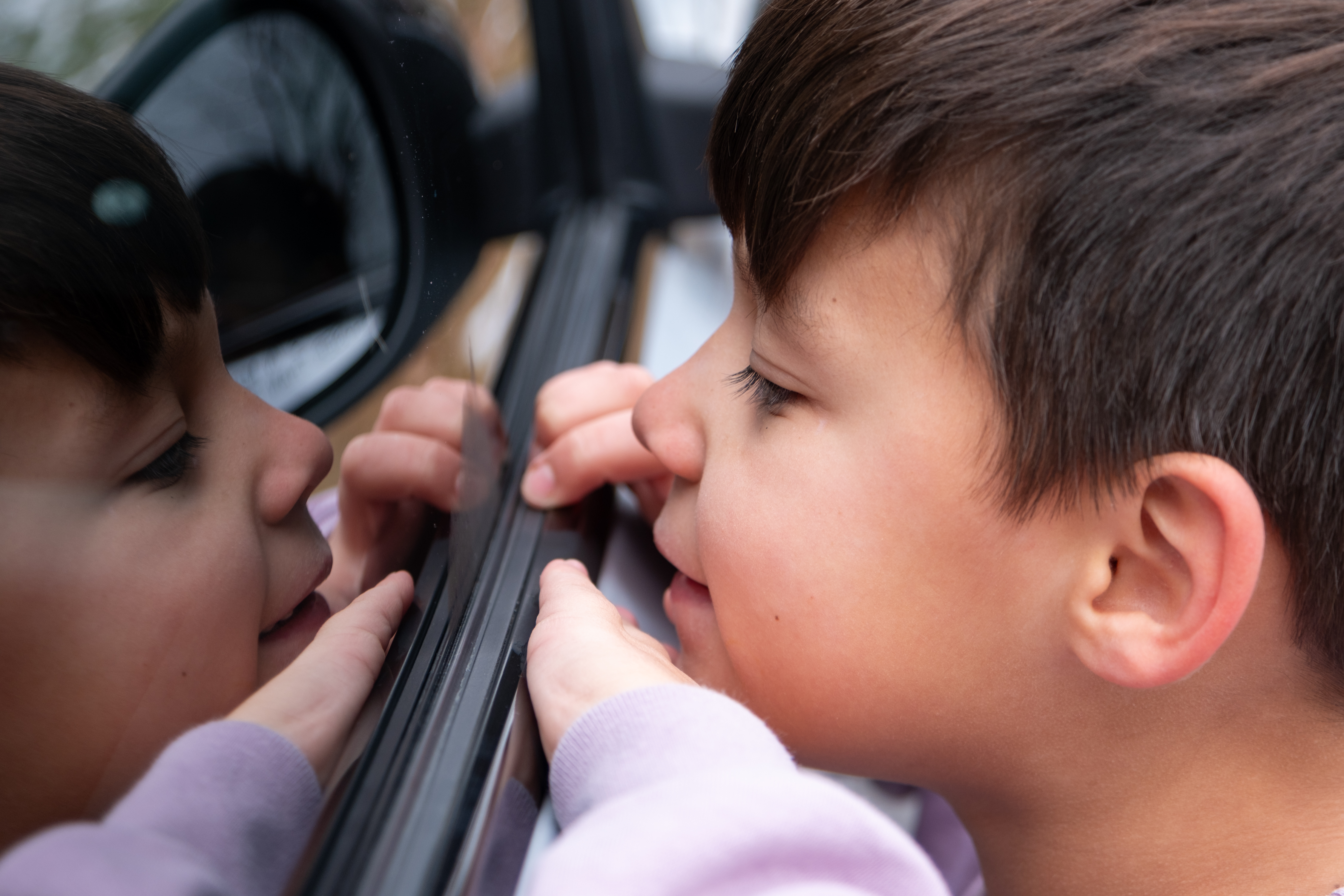 Oliver peering into the Mustang Mach-E's window.