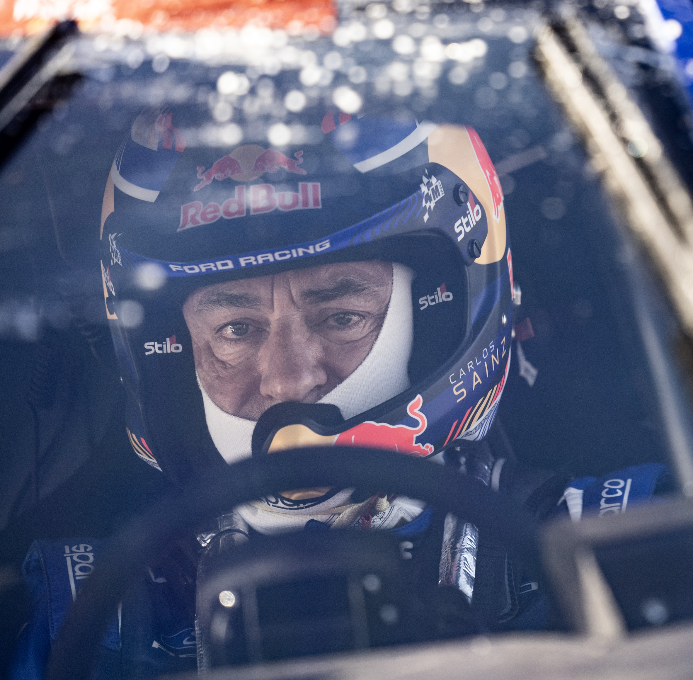 A close-up of Carlos Sainz while driving at Dakar.