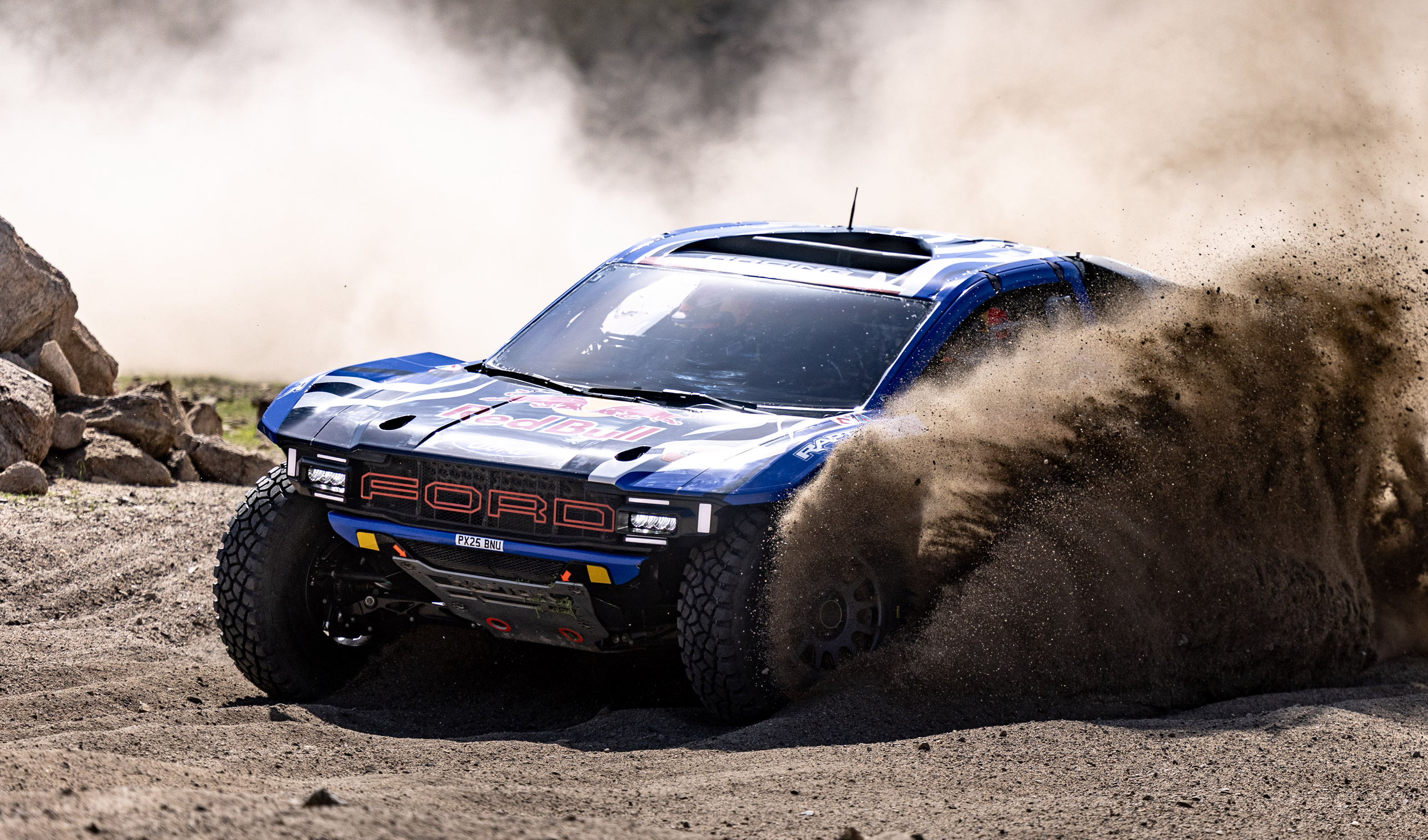 The Ford Raptor T1+ kicks up dust in the desert at Dakar.
